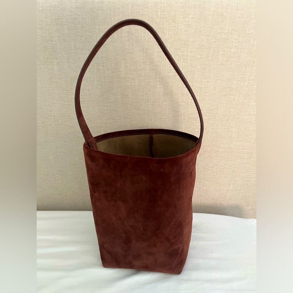 The Row style N/S medium tote in brown suede. Very chic. Real suede